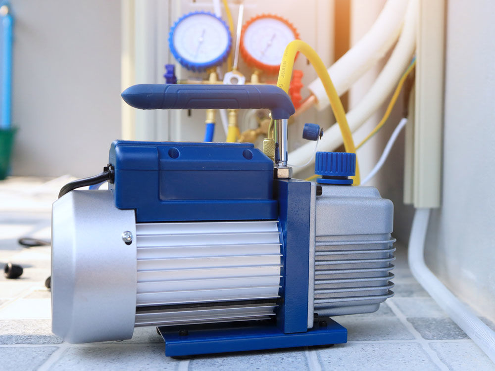 photo of a vacuum pump removing refrigerant.